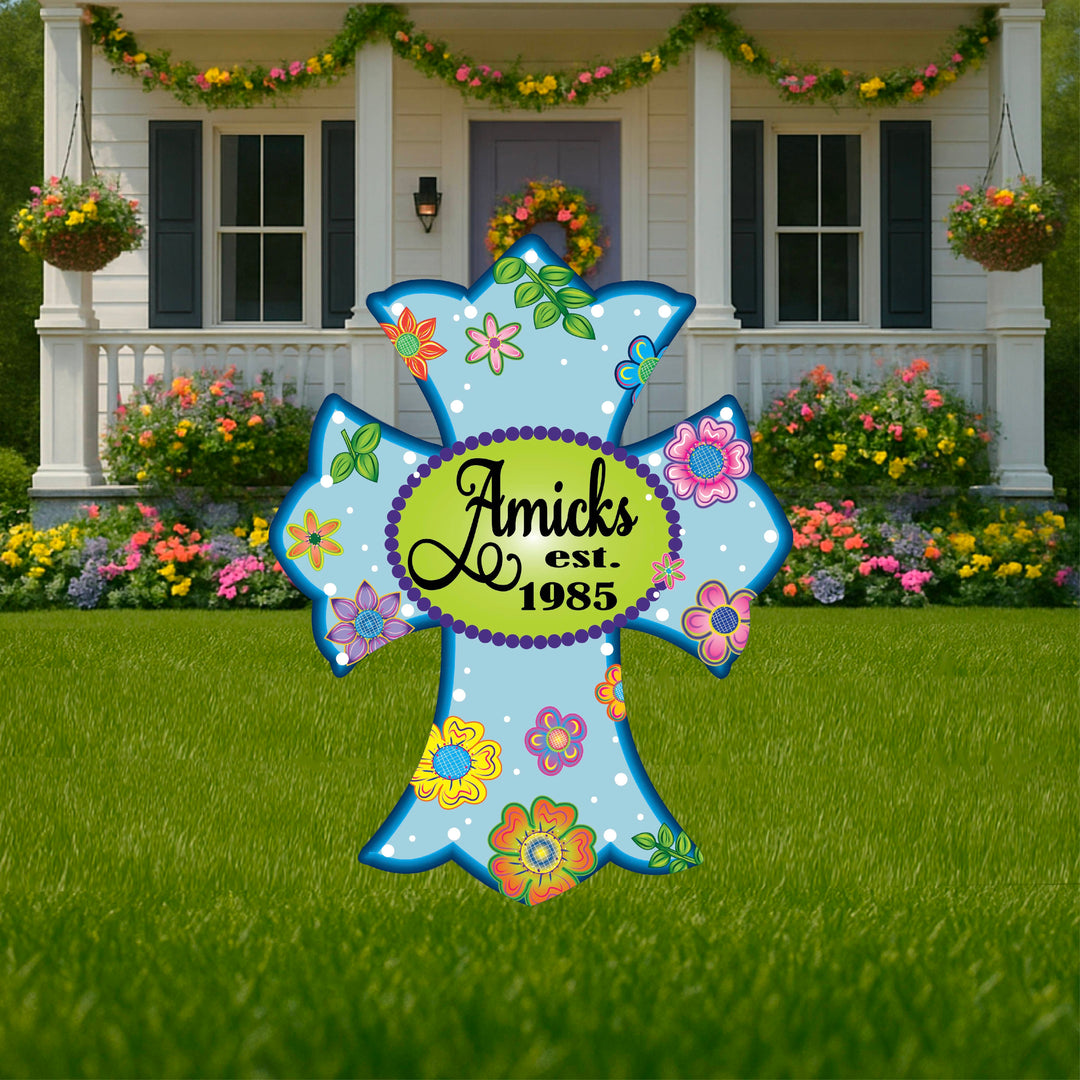 Personalized blue cross yard sign showing last name and year established. Custom cross lawn decor is perfect to celebrate and honor anniversaries, births, home purchases and more. Decorate your yard, porch, walkway, garden or porch with personalized lawn decor from Yard Art Decor and More.