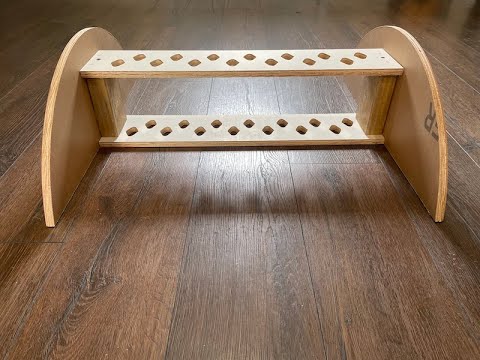 Front view of a custom-designed wooden yard art storage rack with staggered holes for green channel stakes, handmade in Scottsburg, Indiana.