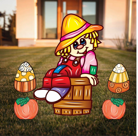 Scarecrow sitting in a Bucket and Fall pumpkins with Candy corns Halloween yard art