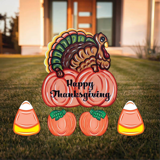 Turkey nesting on Fall Pumpkin with candy corns and pumpkins yard signs