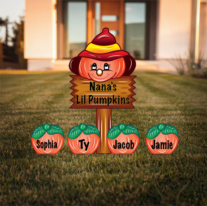 Decorative sign with 'Nana's Lil Pumpkins' and four children's names on a grassy lawn. Personalized custom fall yard art signs with stakes. 