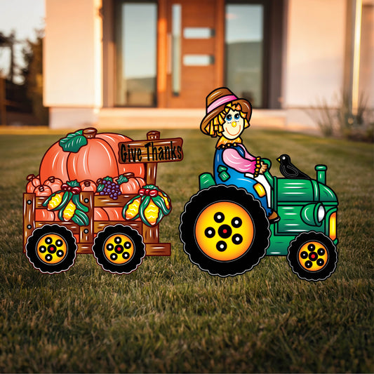 Scarecrow Driving Tractor with Trailer of Pumpkins
