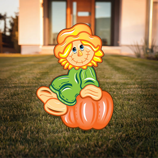 Scarecrow sits on a Pumpkin