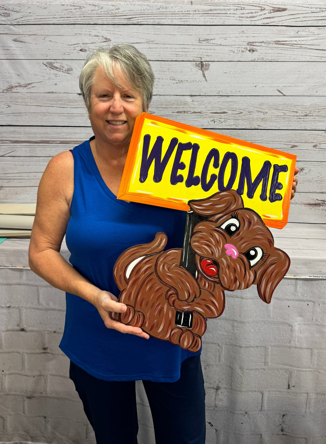 Cute Dog Holding a Welcome Yard Art Sign