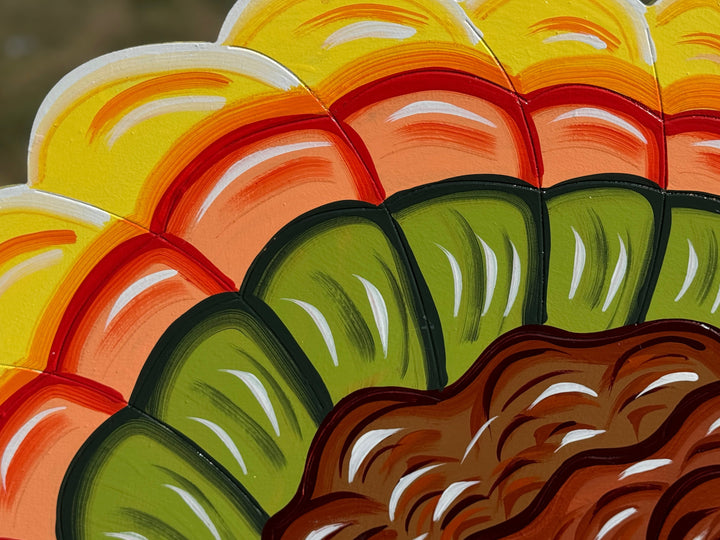Close-up of a colorful patterned fabric with yellow, orange, red, green, and brown colors.