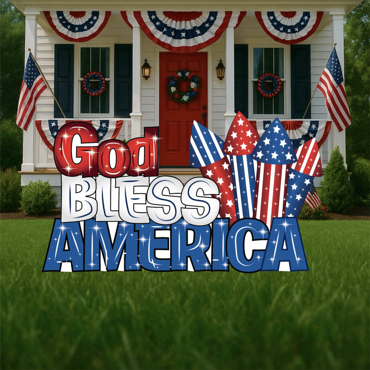 Patriotic outdoor yard art sign that says God Bless America in red, withe and blue with a set of firecracker shaped yard sign as well. 