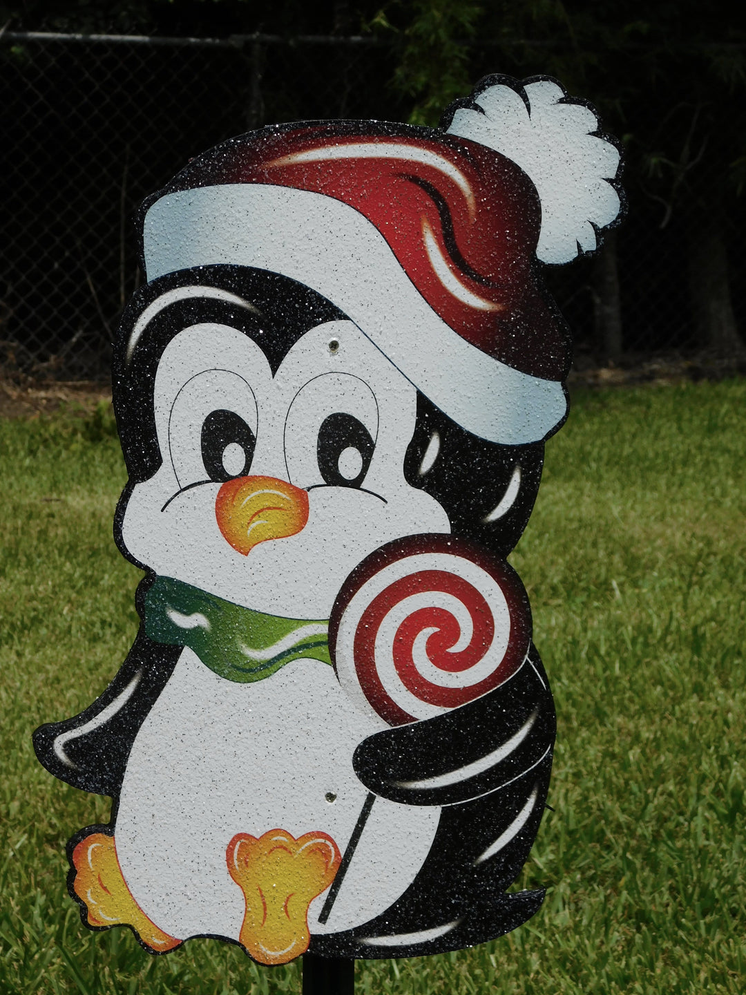 Christmas Penguin with a green stocking hat and peppermint