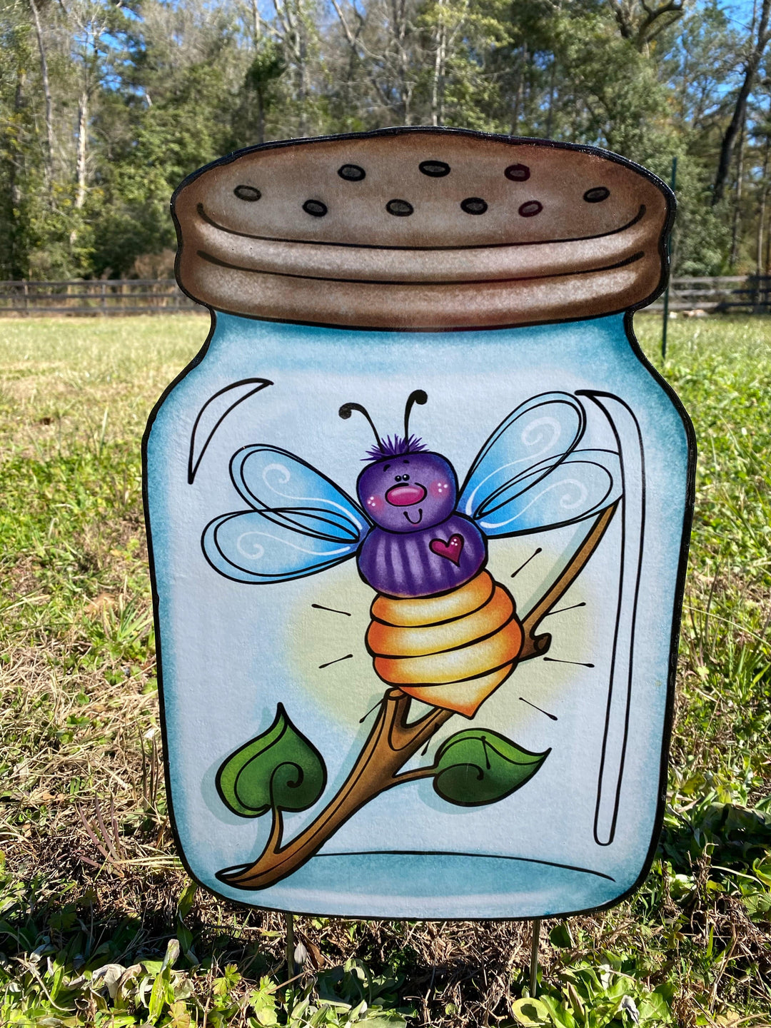 outdoor decorative dragonfly in a jar yard art sign. 