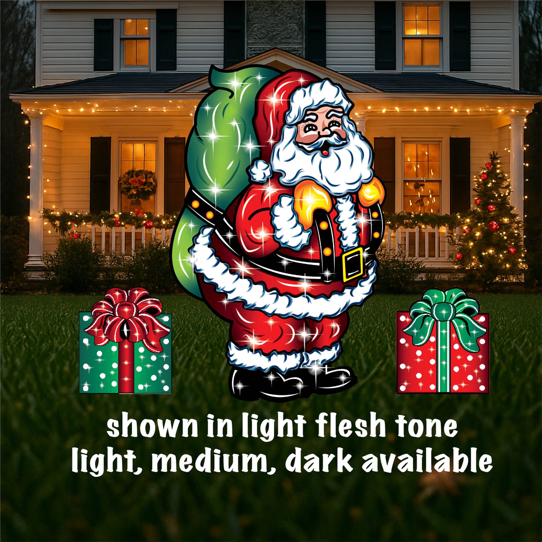 Outdoor Christmas yard sign featuring a colorful illustration of Santa Claus with a green bag, standing next to a lamp post, with presents on the ground. The image shows different sizes of the yard sign with the option to choose light flesh or dark available.