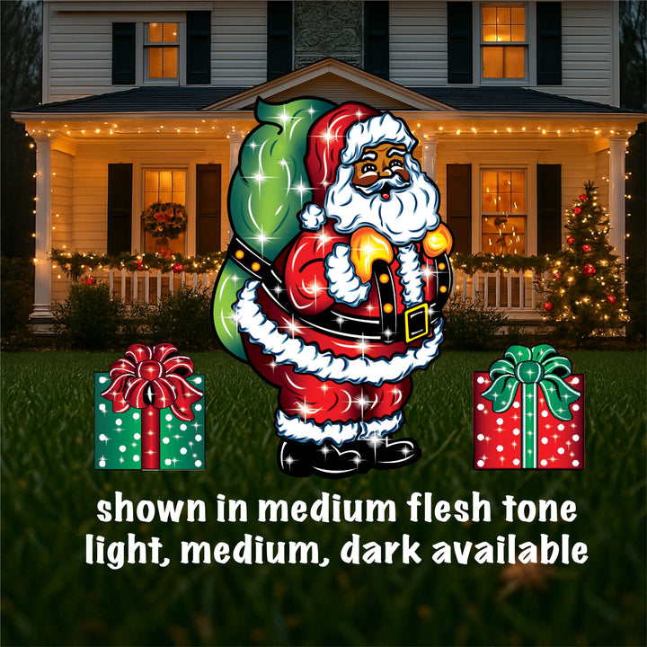 Outdoor Christmas yard sign featuring a colorful illustration of Santa Claus with a green bag, standing next to a lamp post, with presents on the ground. The image shows different sizes of the yard sign with the option to choose light flesh or dark available.