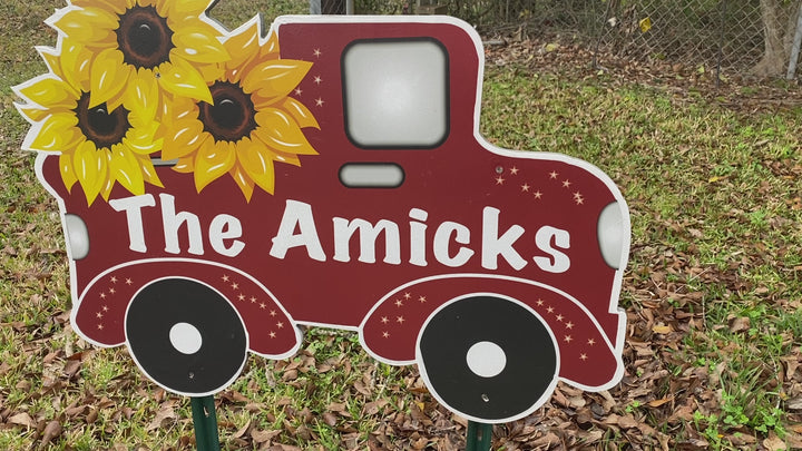 Outdoor personalized yard art sign - red truck with yellow sunflowers. Personalization includes the last name of the family, but can be customized to read anything. 