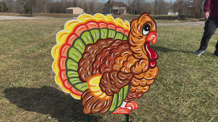 Video of the outdoor decorative turkey yard sign that comes with stakes. Turkey is traditional turkey colors for fall - brown, red, green and yellow. 