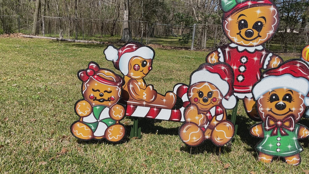 Christmas Gingerbread deccorative outdoor holiday yard signs. Featuring a family of gingerbread people, including Mom, Dad, kids and a baby.  All dressed in festive Christmas Clothing.  Each gingerbread character is set in a glitter finish that will sparkle under outdoor lighting and/or spotlights. Made in the USA and shipped from the USA. 