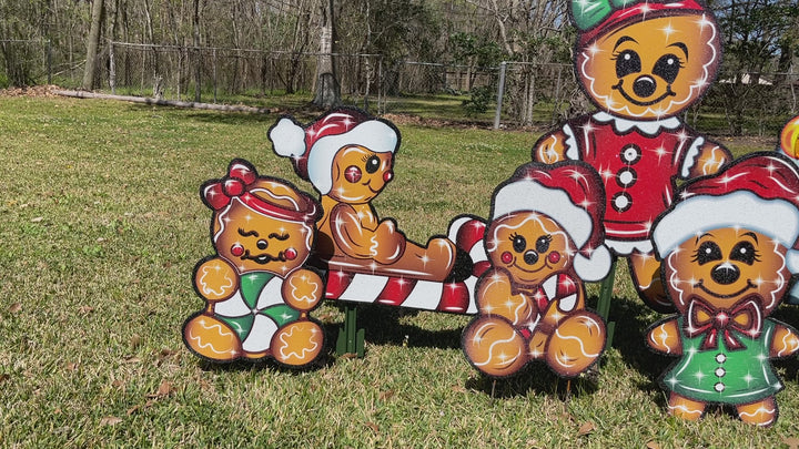 Christmas Gingerbread deccorative outdoor holiday yard signs. Featuring a family of gingerbread people, including Mom, Dad, kids and a baby.  All dressed in festive Christmas Clothing.  Each gingerbread character is set in a glitter finish that will sparkle under outdoor lighting and/or spotlights. Made in the USA and shipped from the USA. 