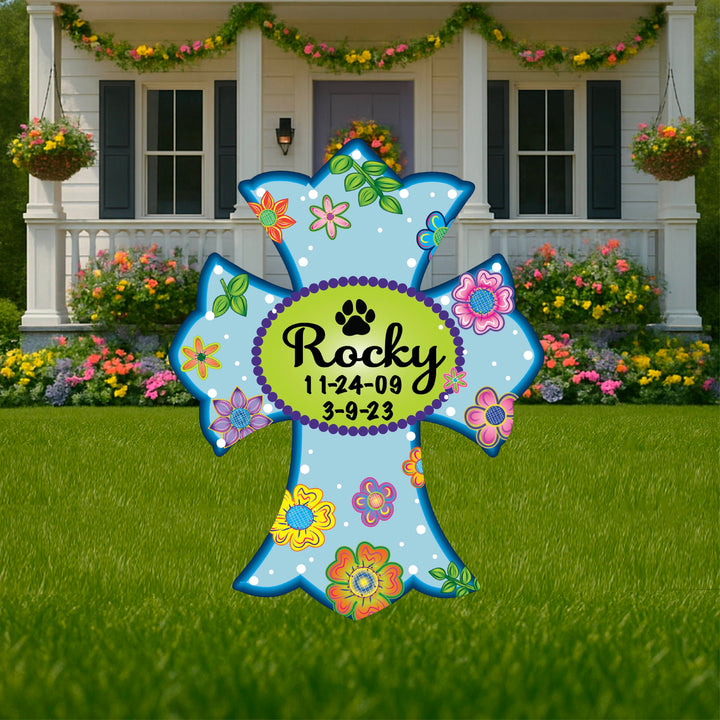Personalized pet memorial outdoor yard sign cross in light blue featuring a custom pet's name of Rocky with their date of birth and death. Custom pet lawn crosses for cats, dogs, birds, lizards, turtles and more available for sale at Yard Art Decor and More. 