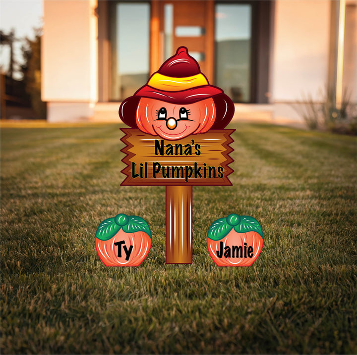 Decorative sign with a pumpkin face and names 'Ty' and 'Jamie' on a grassy lawn. Personalize your outdoor Thanksgiving, Fall or Halloween yard decorations with these adorable pumpkins. 