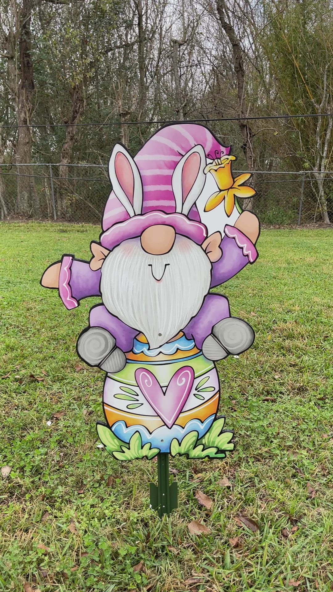 Easter Gnome sits on an Easter Egg Sign Outdoor Decoration
