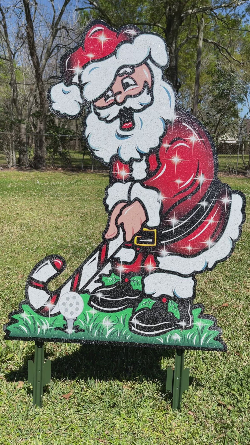 Christmas Golfing Santa Yard decorative yard sign with stakes. Santa in his red santa suit using a candy cane as a golf club. Christmas season outdoor lawn decorations. 