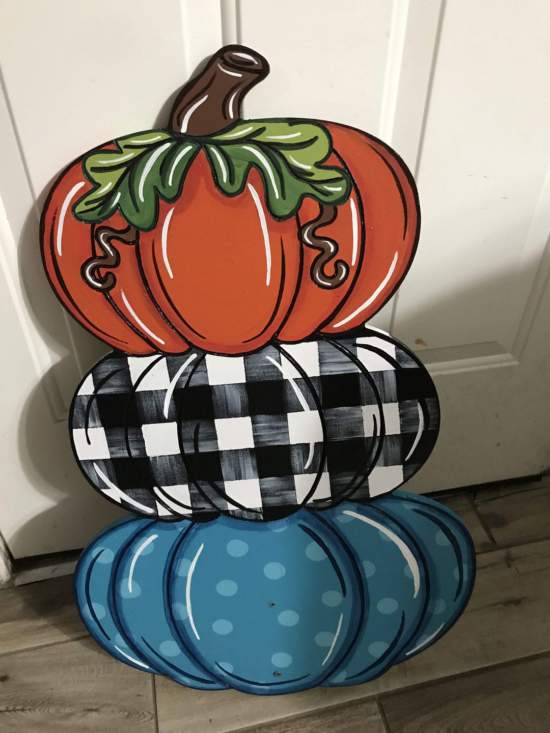triple stack pumpkin with orange, checkard, and blue polka dot pattern painted yard art design