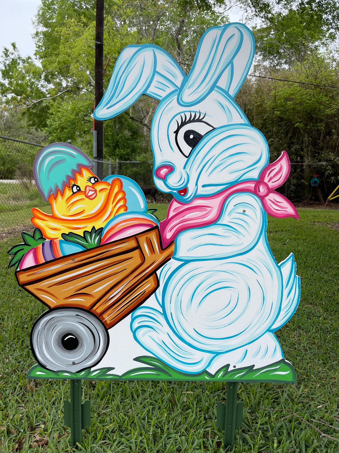 Easter bunny pushes cart of eggs yard art decoration