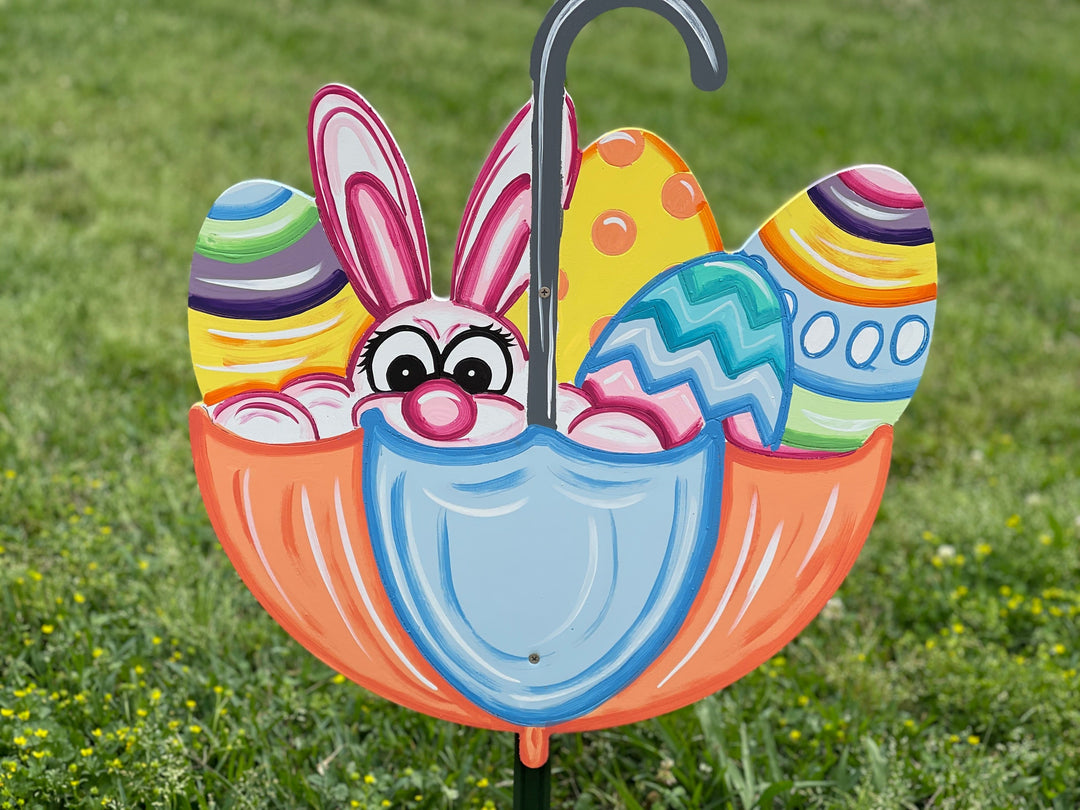 Easter bunny peeking out of umbrella yard art sign