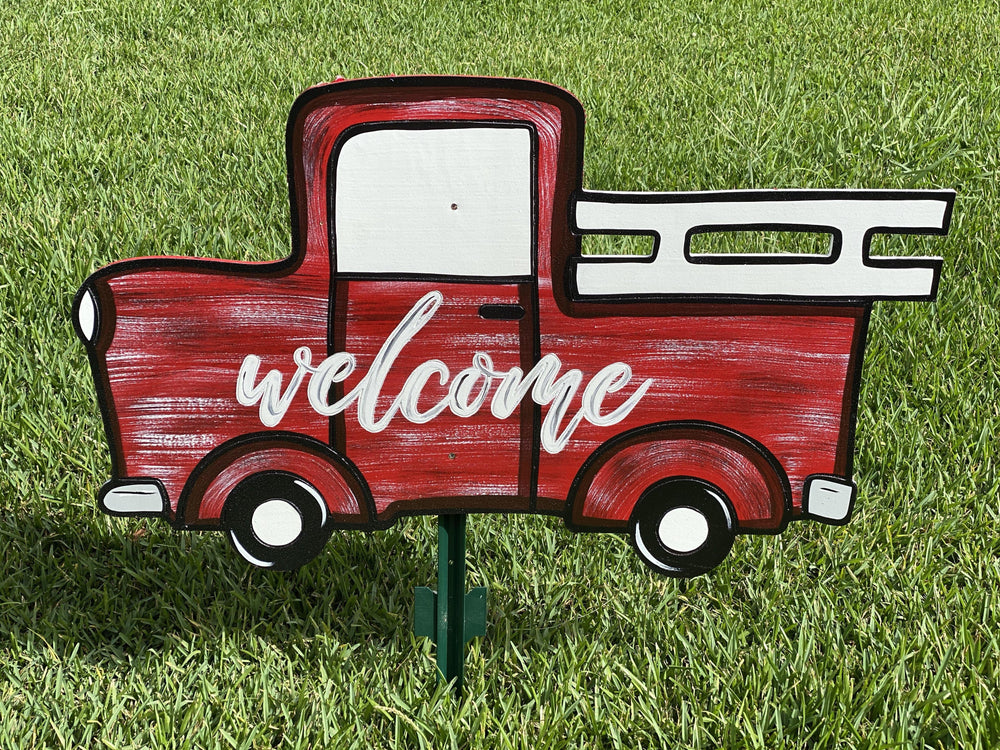 red hand painted truck yard art
