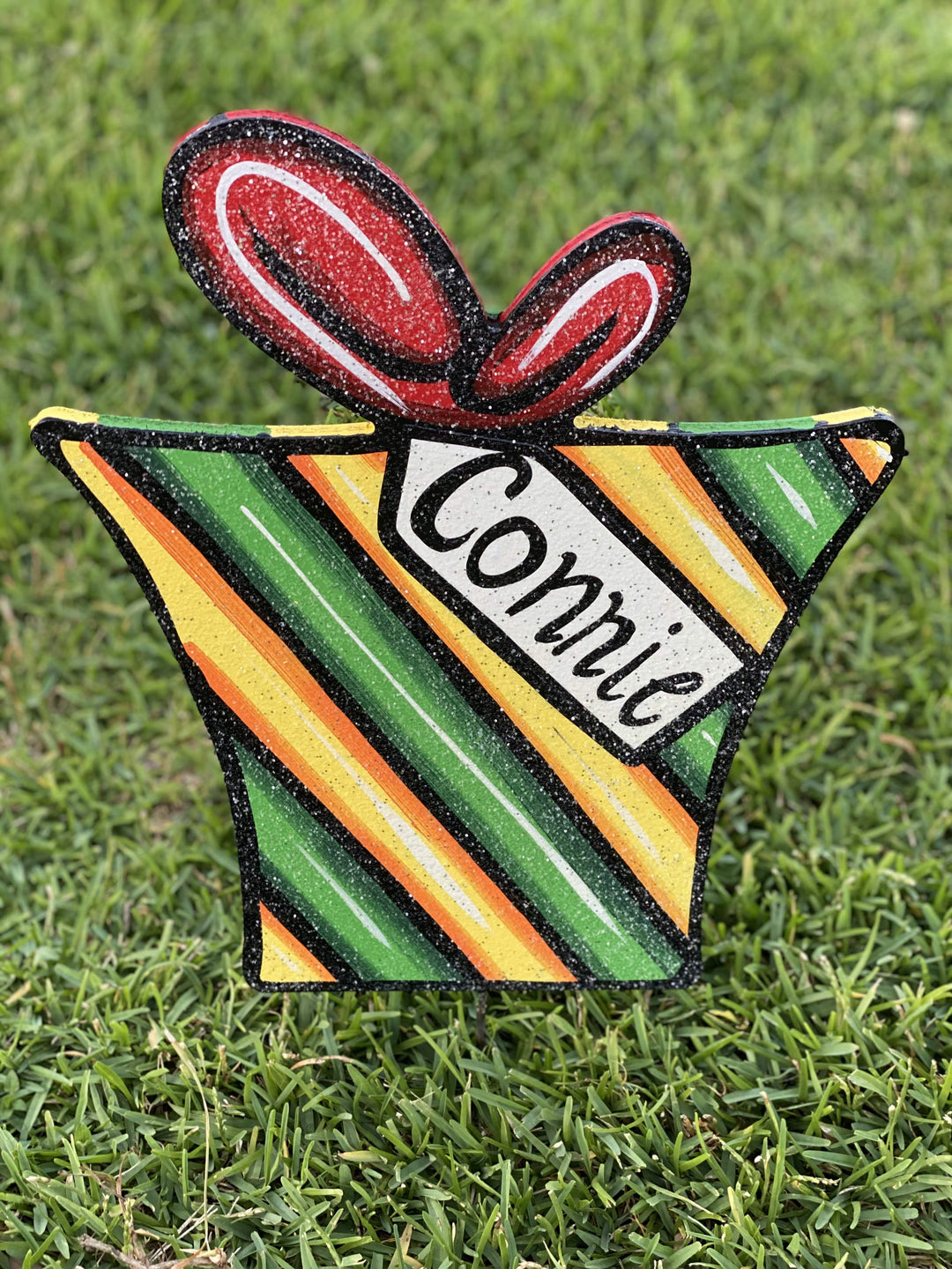 striped Christmas present with tag painted yard art design